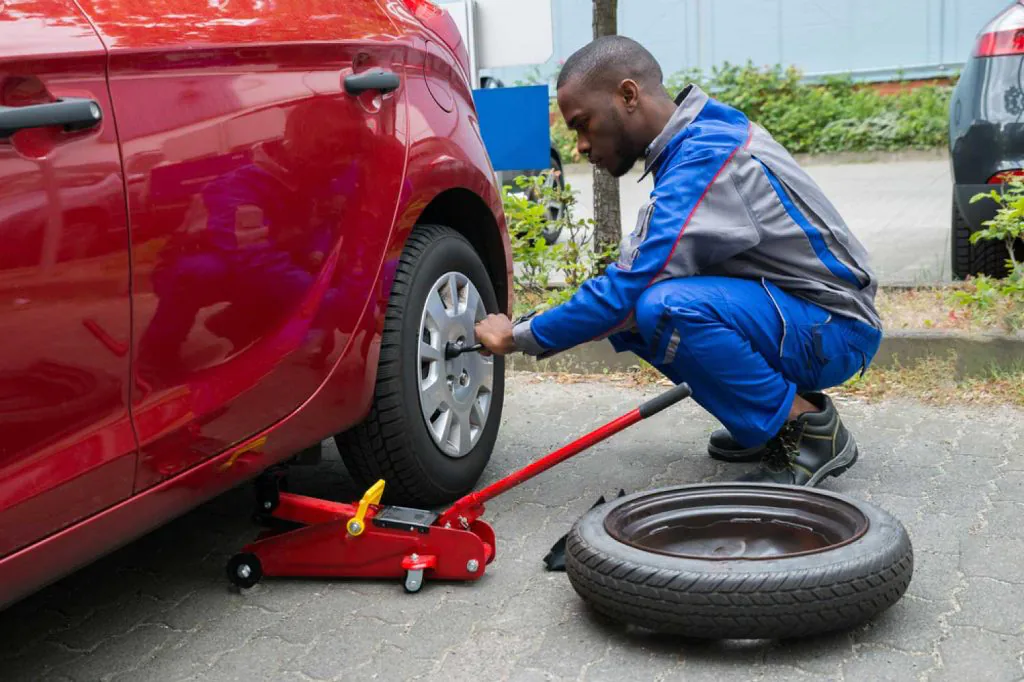 A man pumping a car tire